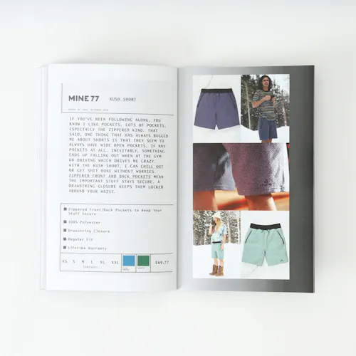 A Mine77 lookbook laying open to product images of a pair of shorts and details about it.