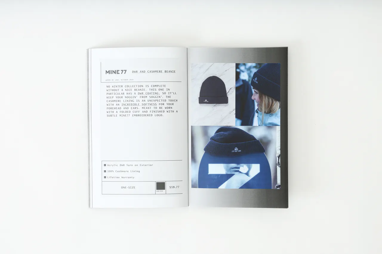 A Mine77 lookbook laying open to images of a cashmere beanie and details about it.