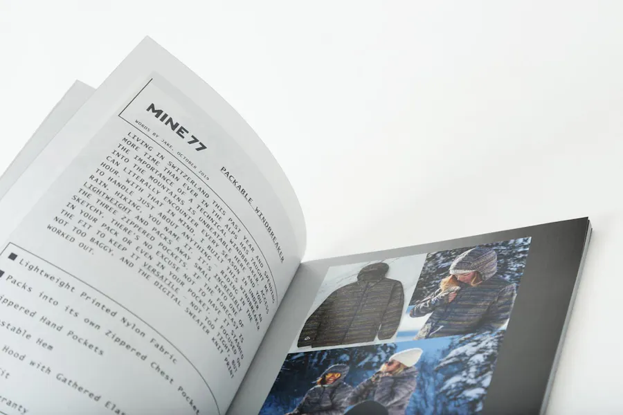A Burton Mine77 lookbook laying open to product details and images of winter jackets.