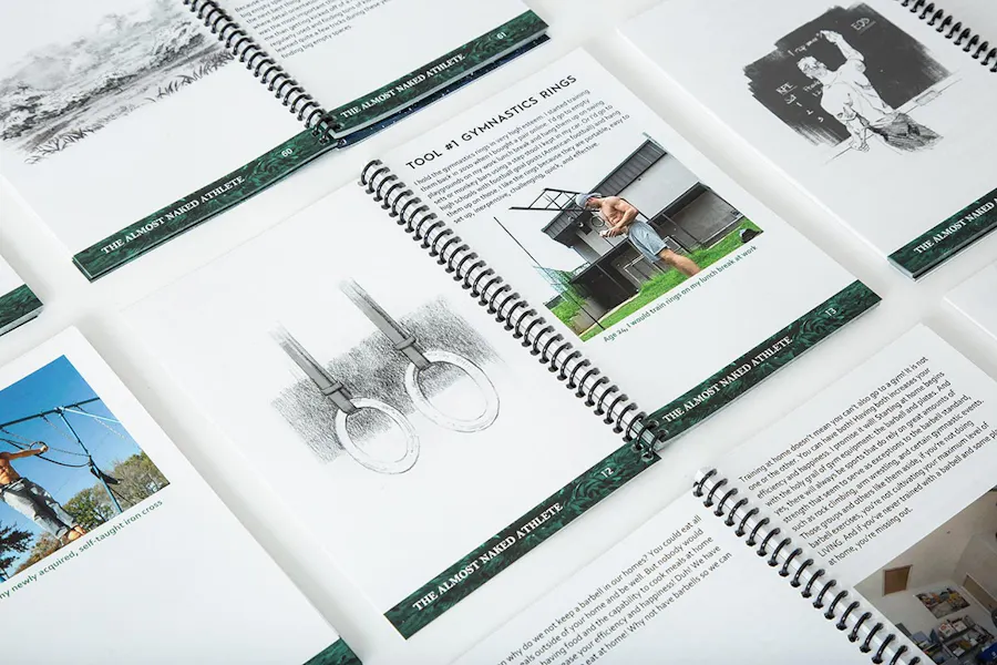 Custom spiral coil booklets printed as training manuals with images of a man with workout equipment.