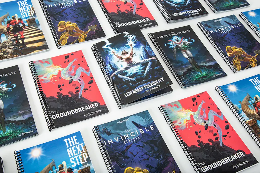 Three rows of training manuals written by Jujimufu with coil bindings and custom cover art.
