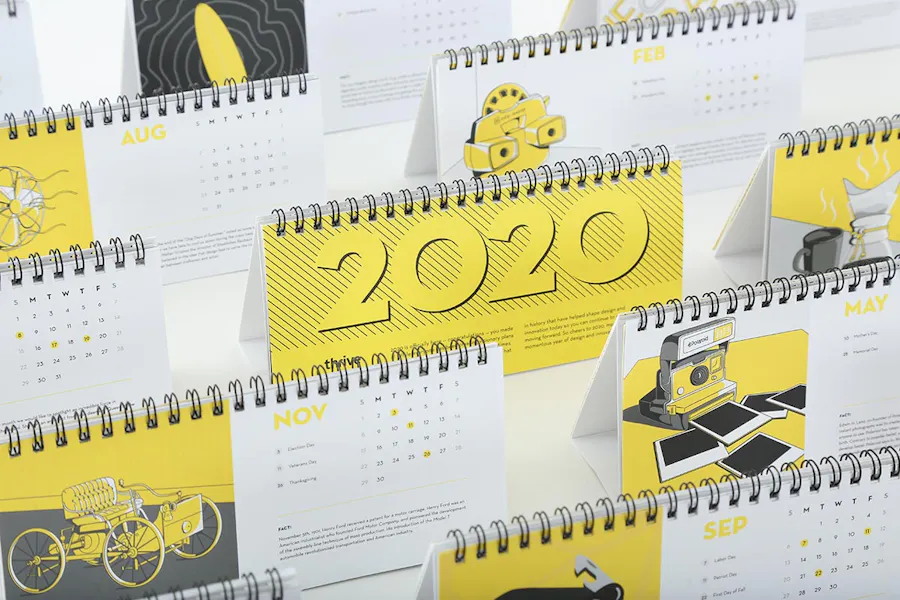 Rows of wire coil calendars standing in line with a yellow, white and black design.