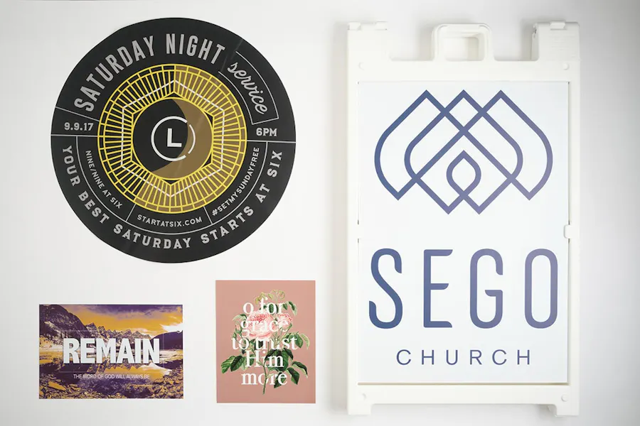 Various custom church signs, including a sidewalk sign, two posters and a floor graphic.