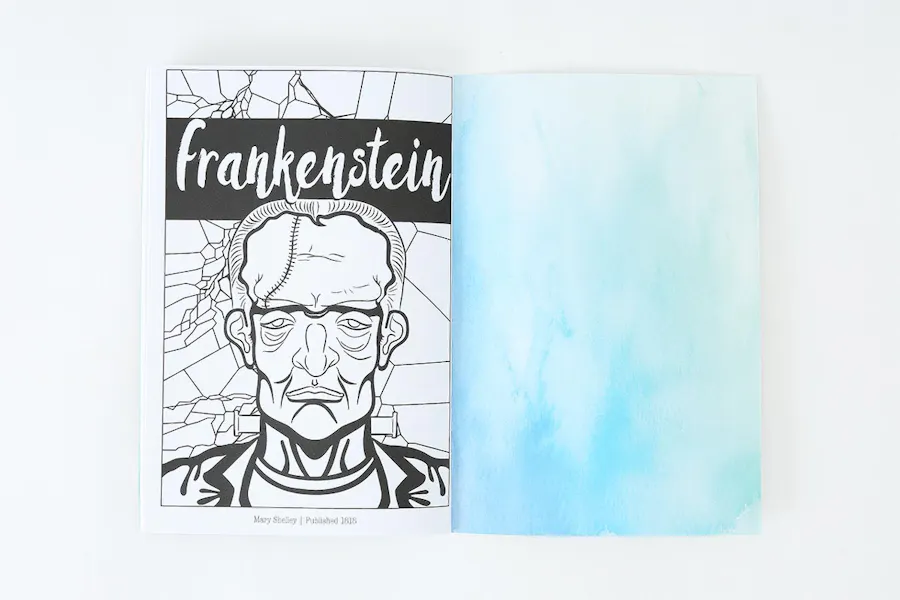 A custom coloring book laying open to a black and white picture of Frankenstein.