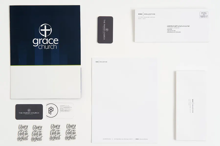 Various church marketing print pieces, including a pocket folder, business envelopes, business cards and stickers.