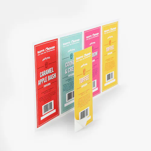 Crack 'n' Peel - 60# Matte White, 13.25 x 7.75, Shown both as a Combo Sheet and a regular Label A sheet of custom labels printed in red, blue, pink and yellow and Scott's Orchard at the top.