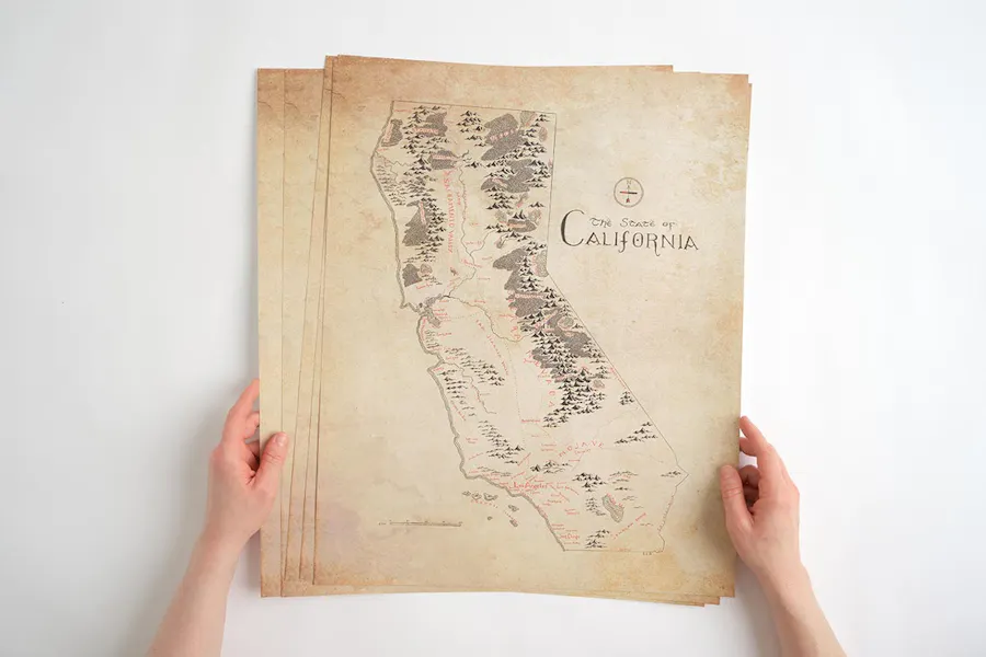 Two hands holding custom marketing posters printed with a detailed map of California.