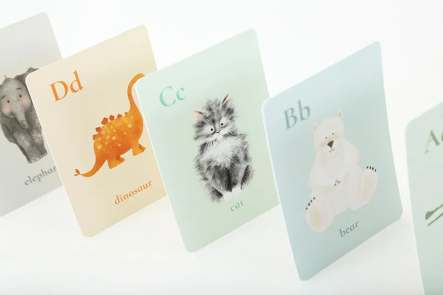 Collated flashcards lined up in a row with uppercase and lowercase letters and animals on each card.