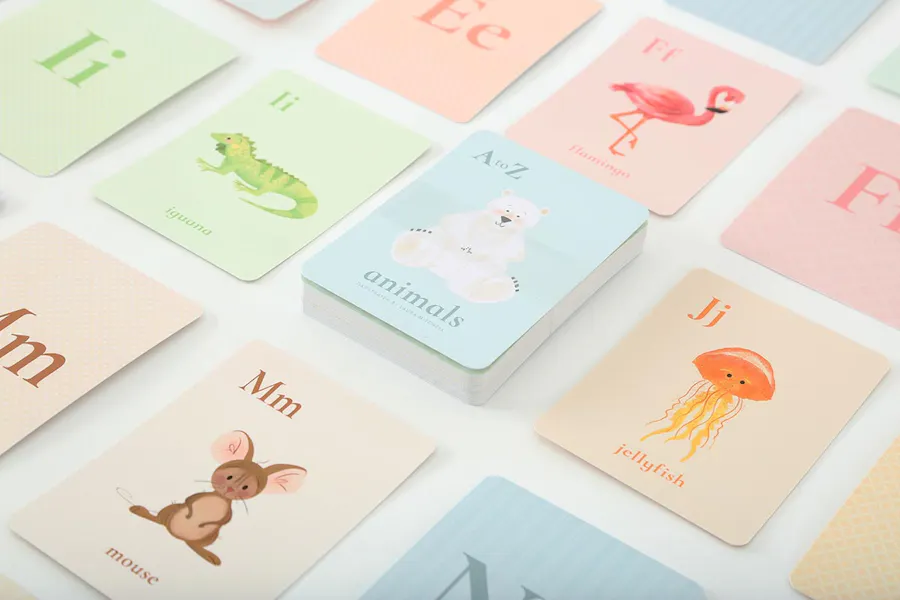 Custom alphabet flashcards lined up in rows with pastel colors and letters with corresponding animals on each one.