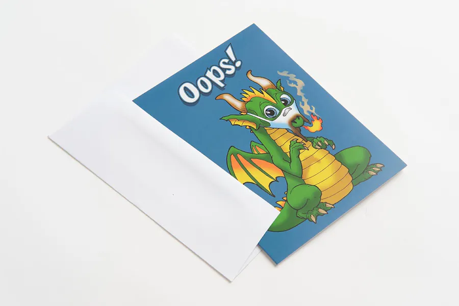 A custom greeting card with a blue background and a dragon on the front with a white envelope.