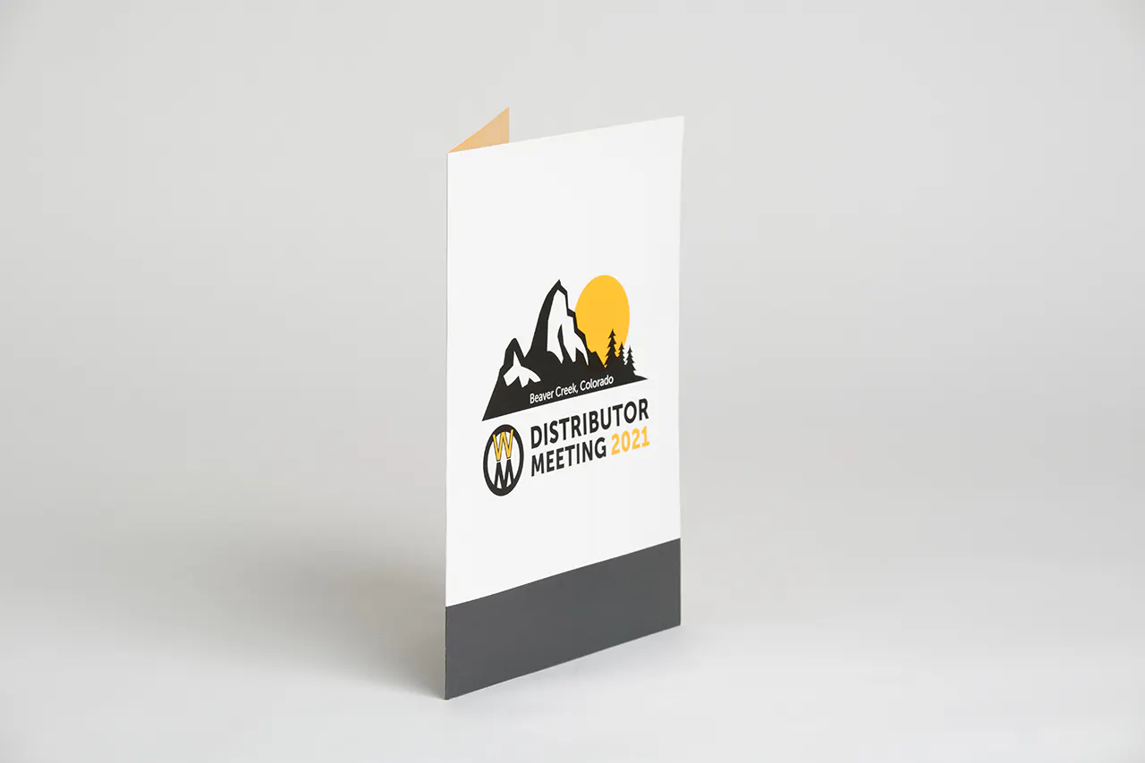 A custom pocket folder printed with Distributor Meeting 2021 in black and yellow on the front.