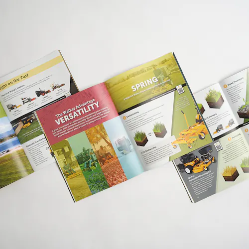 Three Walker Mower marketing catalogs laying open and overlapping each other with mower info and imagery.
