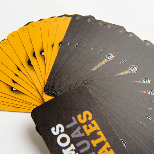 A stack of Walker Mower product flashcards fanned out in a circle with a black and yellow design.