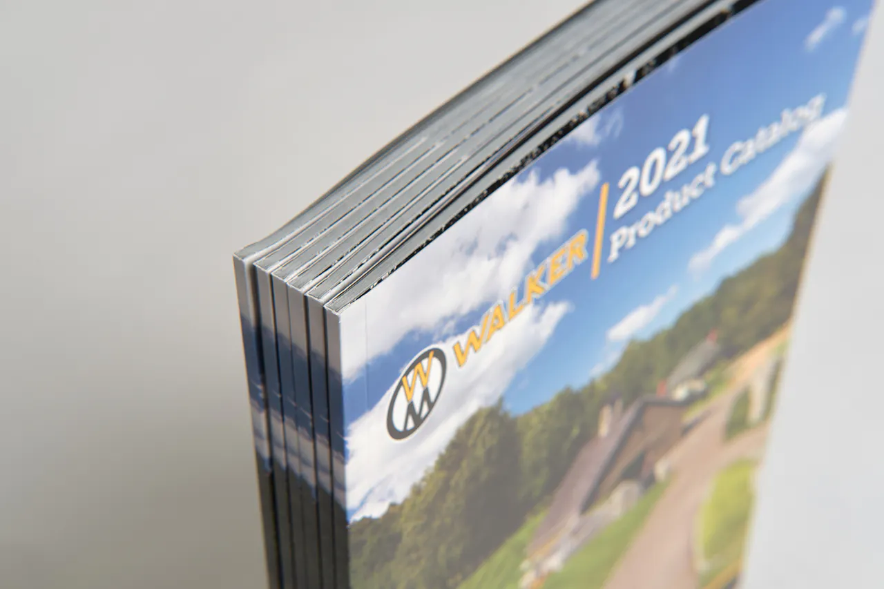 A stack of six standing Walker Mower product catalogs with perfect bindings and 2021 on the cover.