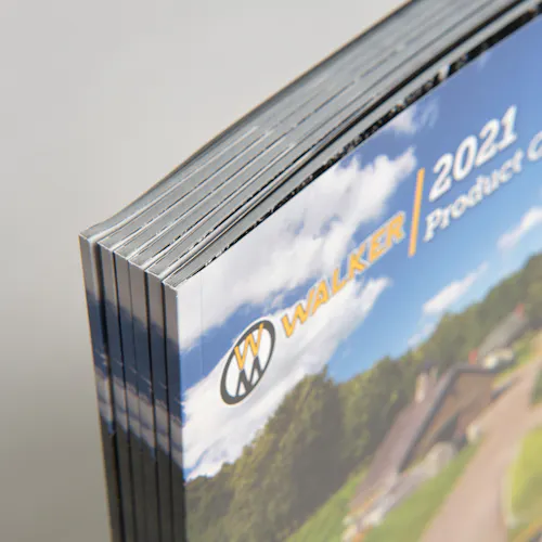 A stack of six standing Walker Mower product catalogs with perfect bindings and 2021 on the cover.