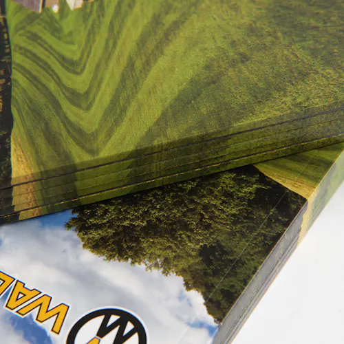 A stack of Walker Mower product catalogs with a perfect binding and bright green grass on the covers.