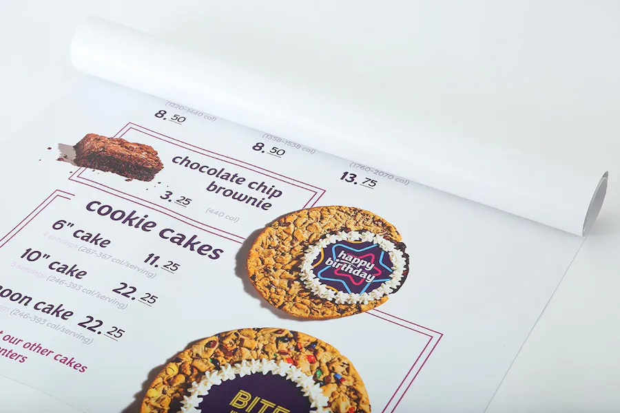 An Insomnia Cookies menu unrolling to reveal images of cookie cakes and pricing details.