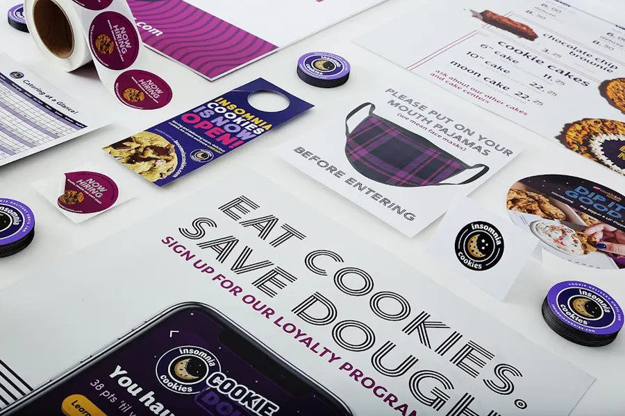 Various print marketing materials for Insomnia Cookies, including posters, stickers, door hangers and magnets.