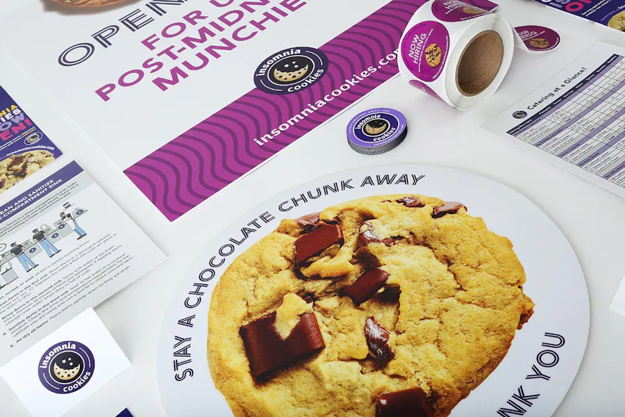 Branded print materials for Insomnia Cookies, including posters, stickers, magnets and catering and safety flyers.