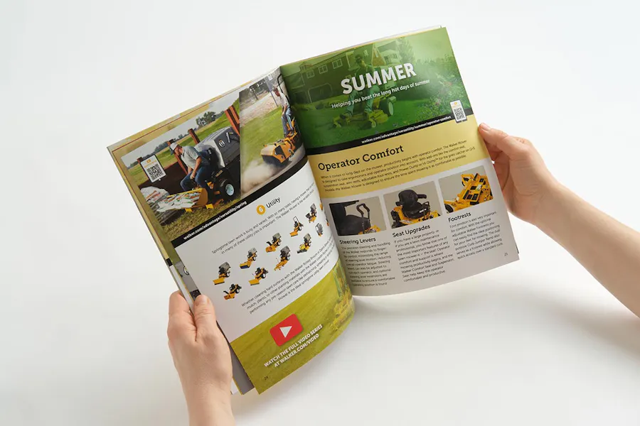 Two hands holding a product catalog open to images of a landscaping business.