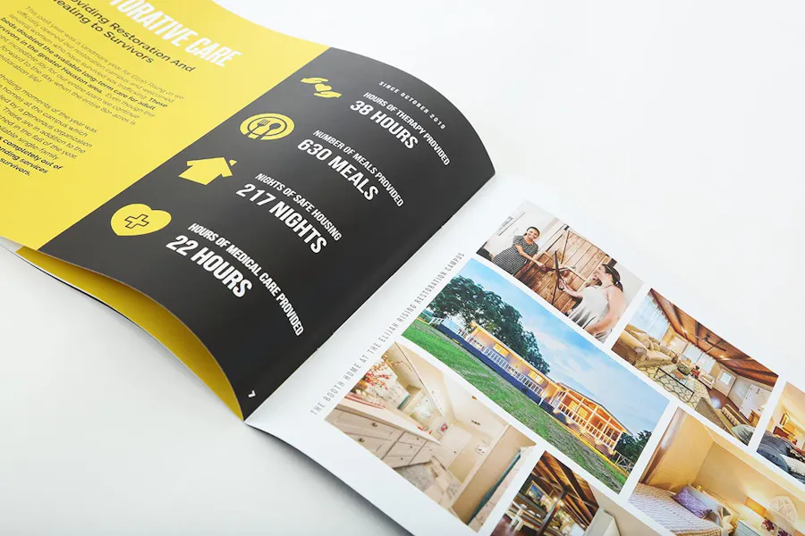 An annual report booklet laying open to company stats and images of a house and its rooms.