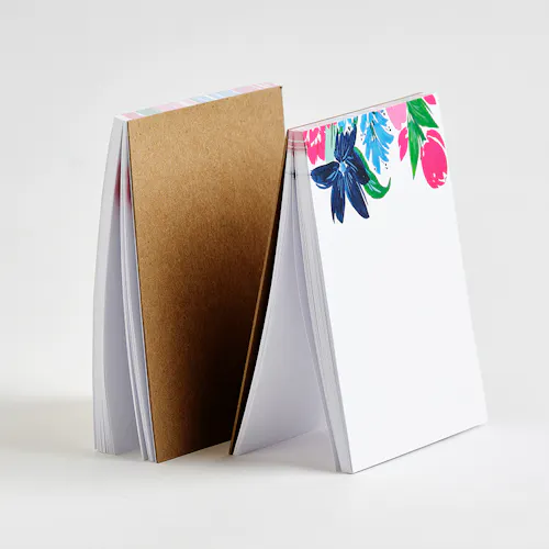 70# UNCOATED SMOOTH WHITE TEXT PAGES WITH CHIPBOARD BACKING, 4.25 X 5.5" Two custom printed notepads with a bright floral design at the top.