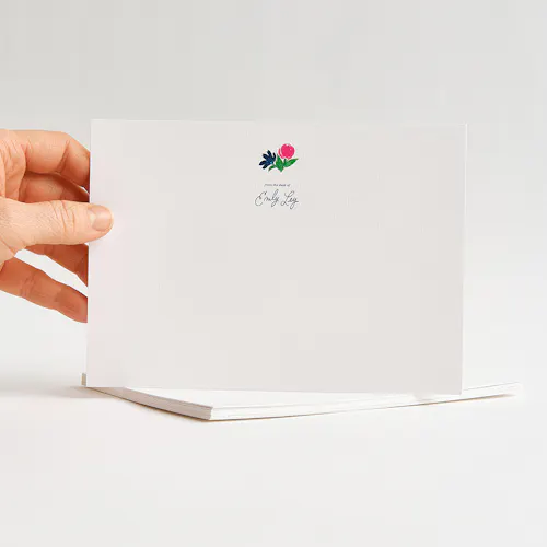 INVITATION: 110# LINEN WHITE COVER, 5 x 7" A hand holding a piece of custom stationery printed with From the Desk of Emily Ley and a floral design.