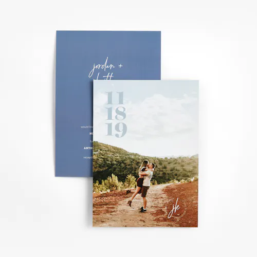 Two wedding save the date cards printed with a man and woman hugging one one side and a blue design on the other side.
