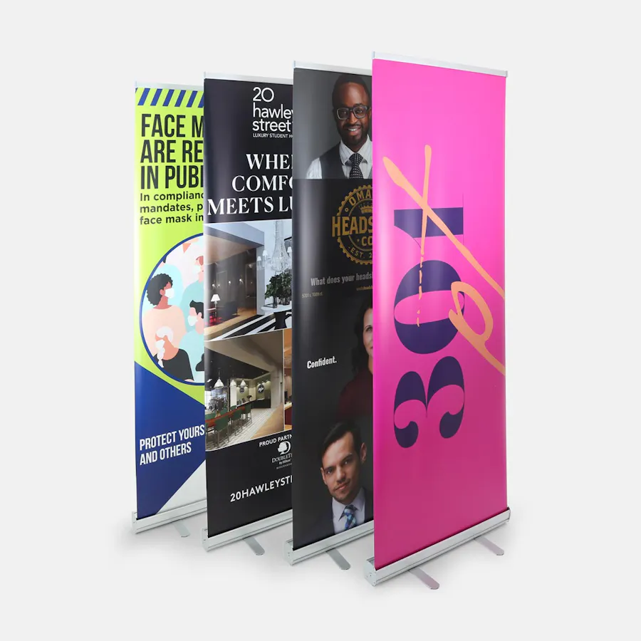 Four custom pop-up banners standing in a row with business advertisements and safety messaging.