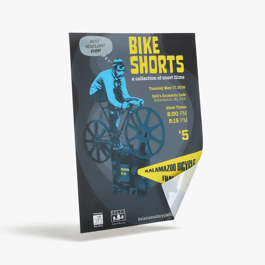 A backlit sign printed with "Bike Shorts" in yellow and the bottom right corner folded back.