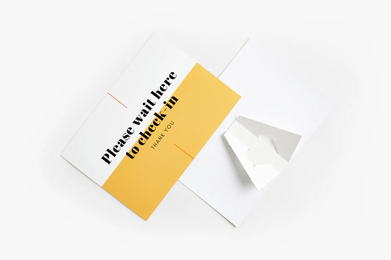 A cardstock sign printed with Please wait here to check in with a yellow and white design.