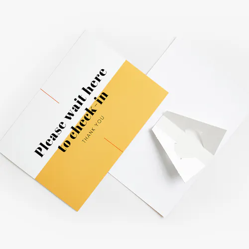 A cardstock sign printed with Please wait here to check in with a yellow and white design.