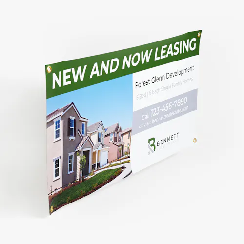 A real estate banner printed with New and Now Leasing at the top and an image of houses lined up in a row.