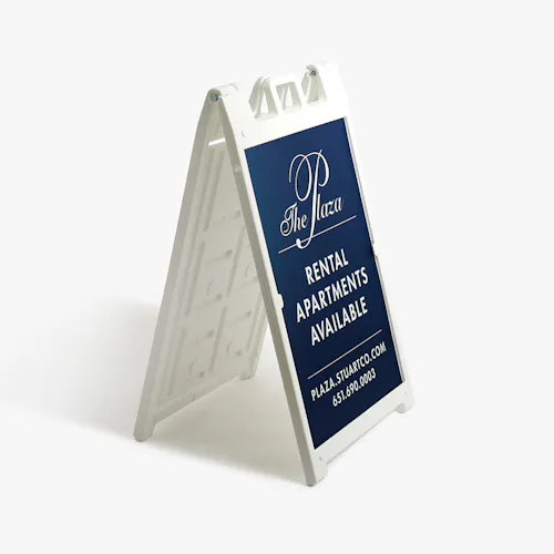 A-FRAME SIDEWALK SIGN: STYRENE O40, 24.5 X 36" A white A-frame stand with a navy blue sign printed with The Plaza Rental Apartments Available in white.