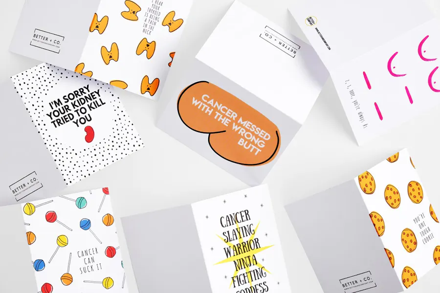 Custom greeting cards laying open with cancer-related designs and phrases.