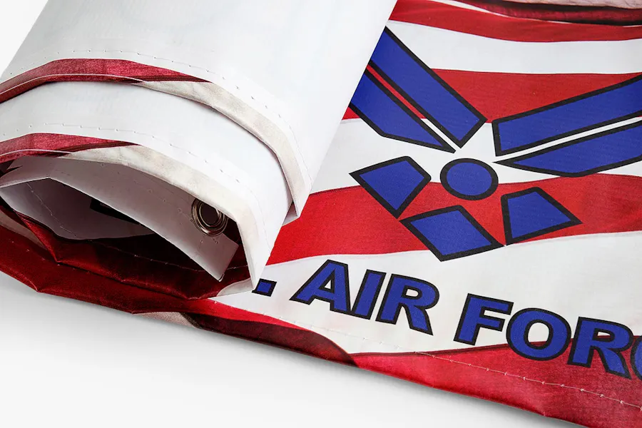 A custom hanging banner with an Air Force design being rolled up.