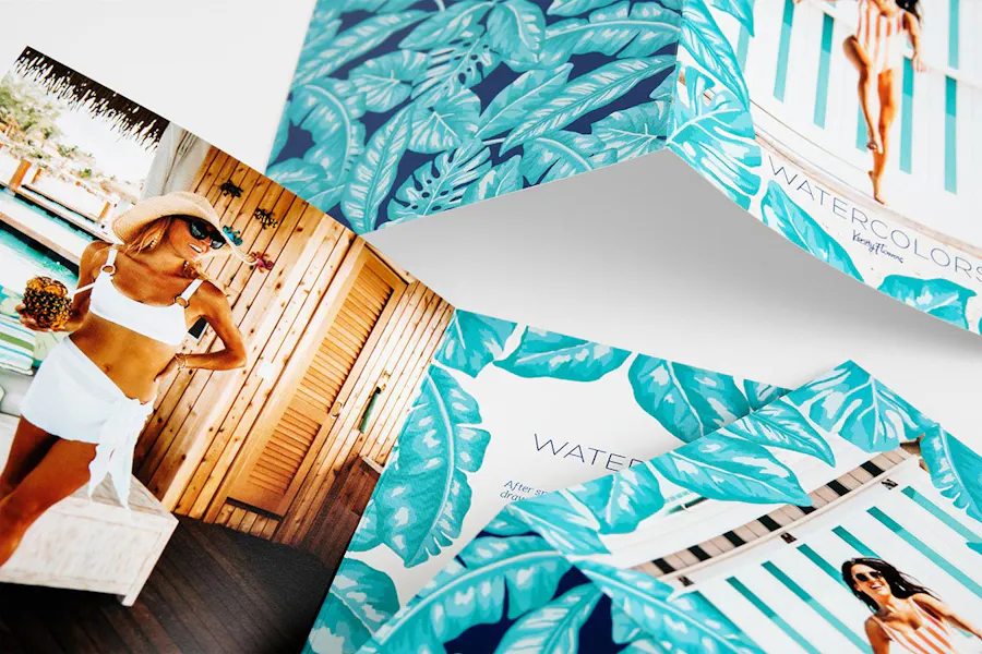 Three summer marketing brochures with beachy designs showing women in swimsuits.