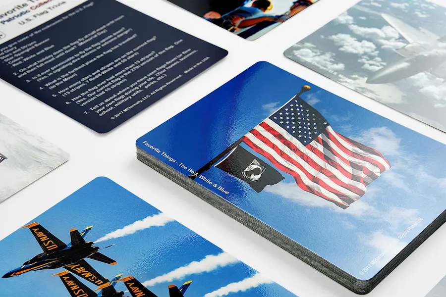 Two rows of collated cards printed with patriotic designs like military aircraft and flags.
