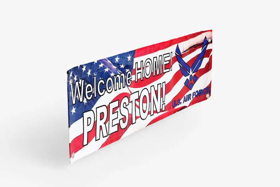 A patriotic banner with a flag design and grommets in the corners for hanging.