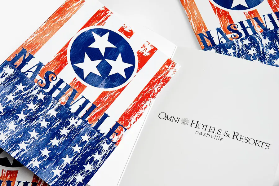 Custom hotel invitations with patriotic branding on the cover.