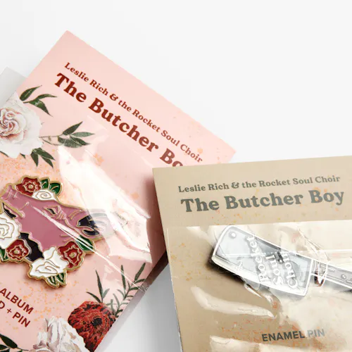 BUSINESS CARDS: TOP: 120# COATED MATTE WHITE COVER, 6 X 2.4" FOLDED TO 3.5 X 2.4". BOTTOM: 120# COATED MATTE WHITE COVER, 2.4 X 2.4" Two pins on custom backers printed with Leslie Rich & the Rocket Soul Choir in pink and tan.