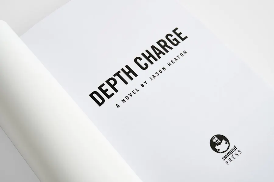 The front cover of a paperback book rolled open with Depth Charge on the first page.
