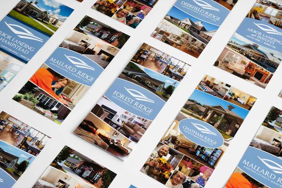 Custom assisted living brochures lined up in five rows printed with Forest Ridge in white.