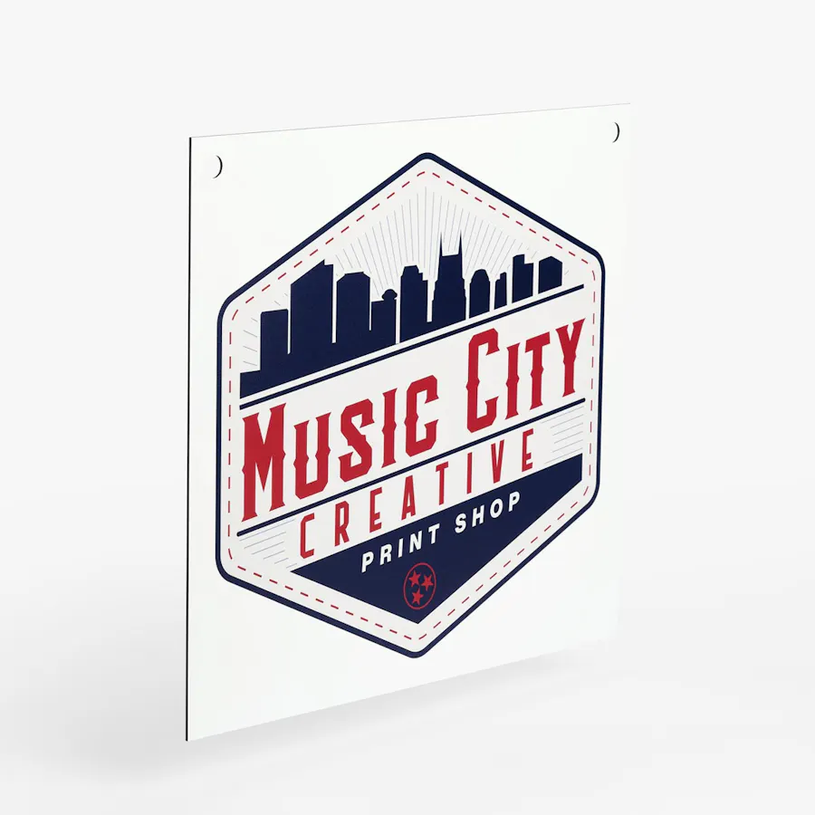 A custom aluminum sign with Music City Creative in red letters and the Nashville, Tennessee skyline in blue.