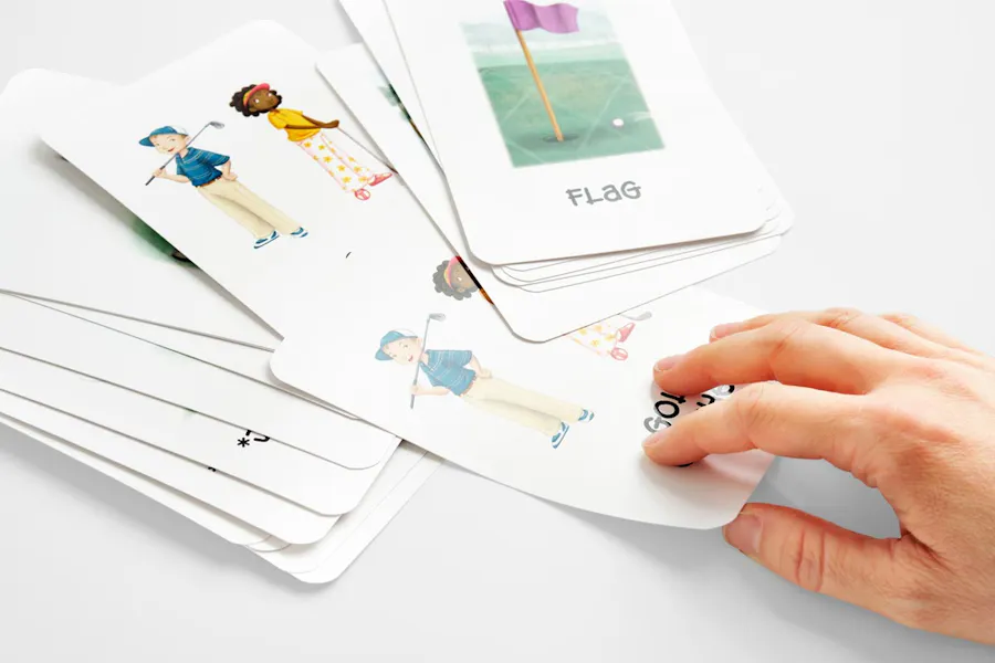 A hand pulling one sports flashcard from a stack of them.