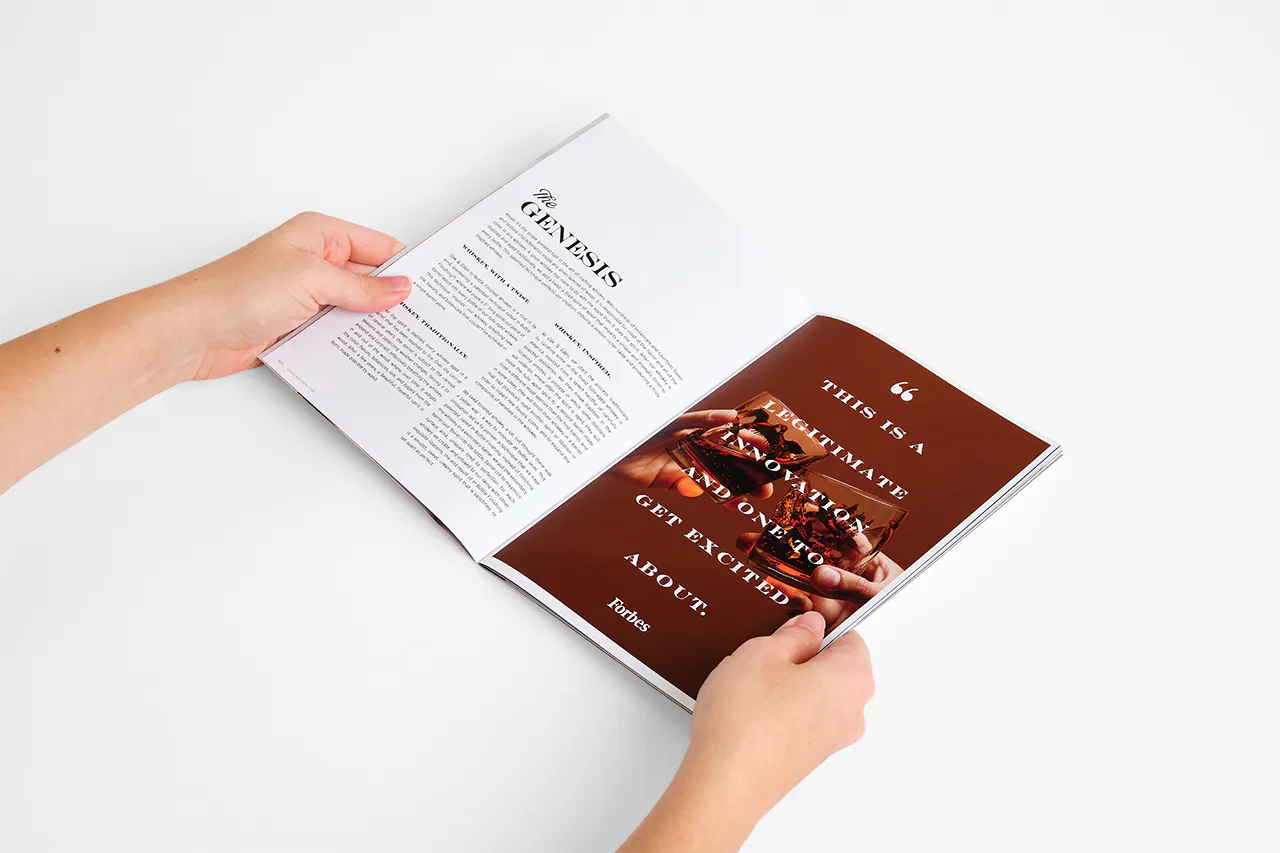 Two hands holding an Oak & Eden marketing booklet open to information about the brand.