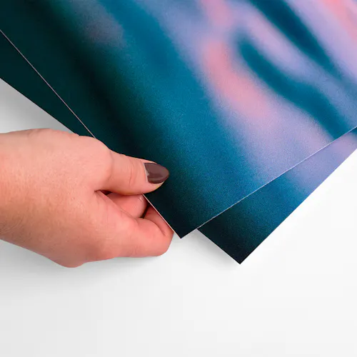 Post-Consumer Waste Cardstock A hands holding the corner of post-consumer waste cardstock printed with a dark water scene.