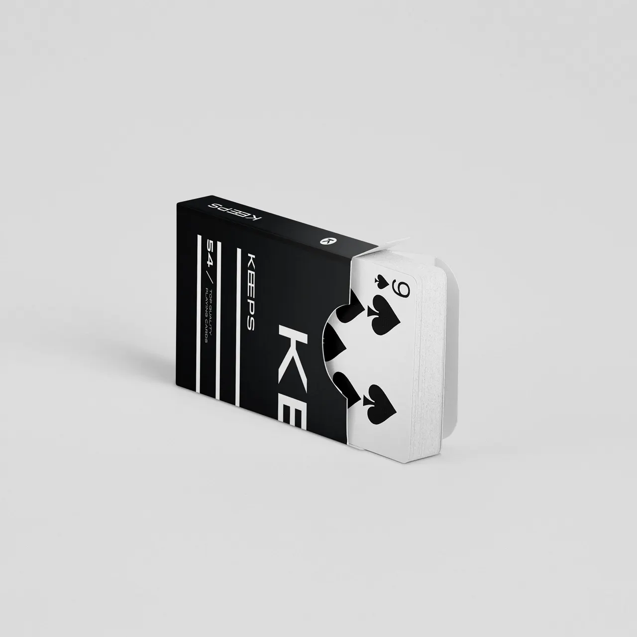 A deck of cards in a black packaging box laying on its side with the cards coming out.