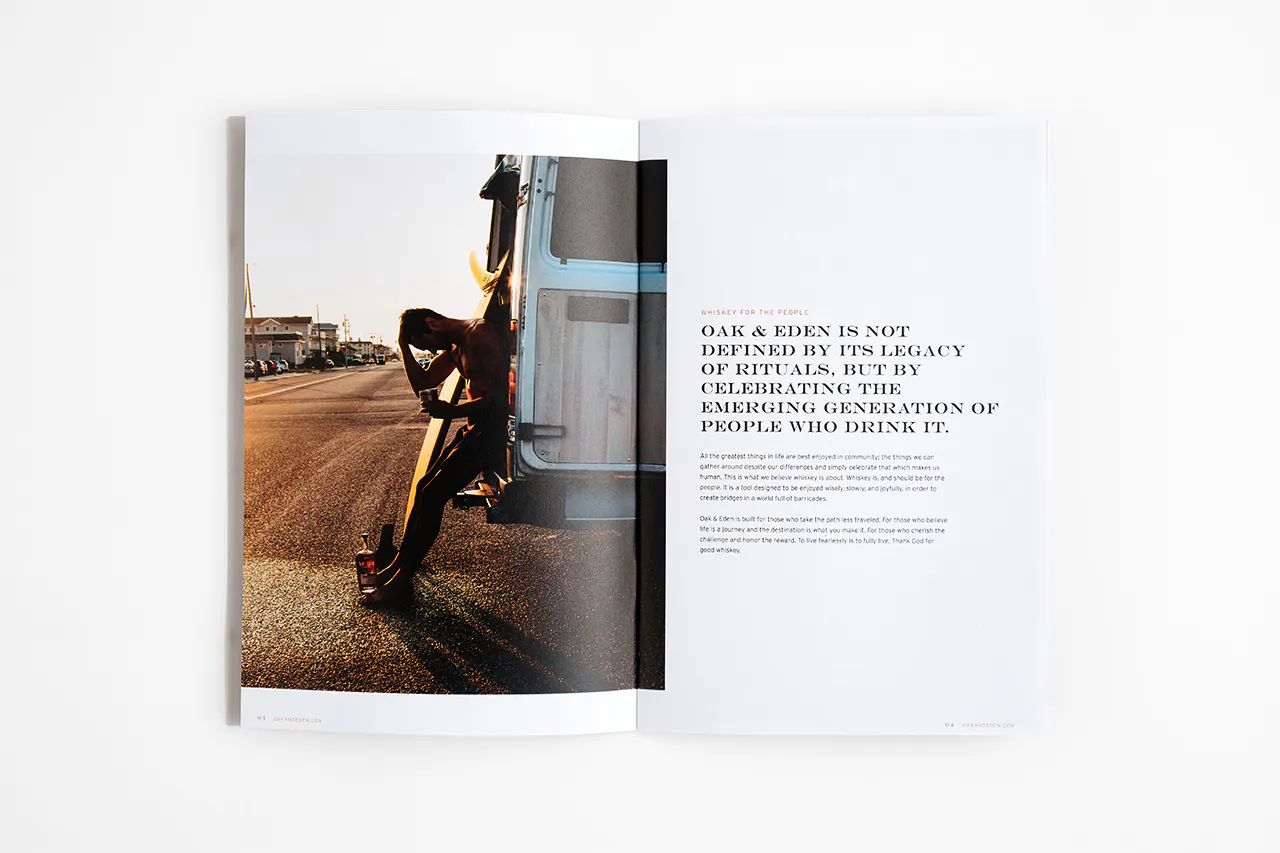 An Oak & Eden marketing booklet laying open to an image of a surfer leaning against his vehicle.