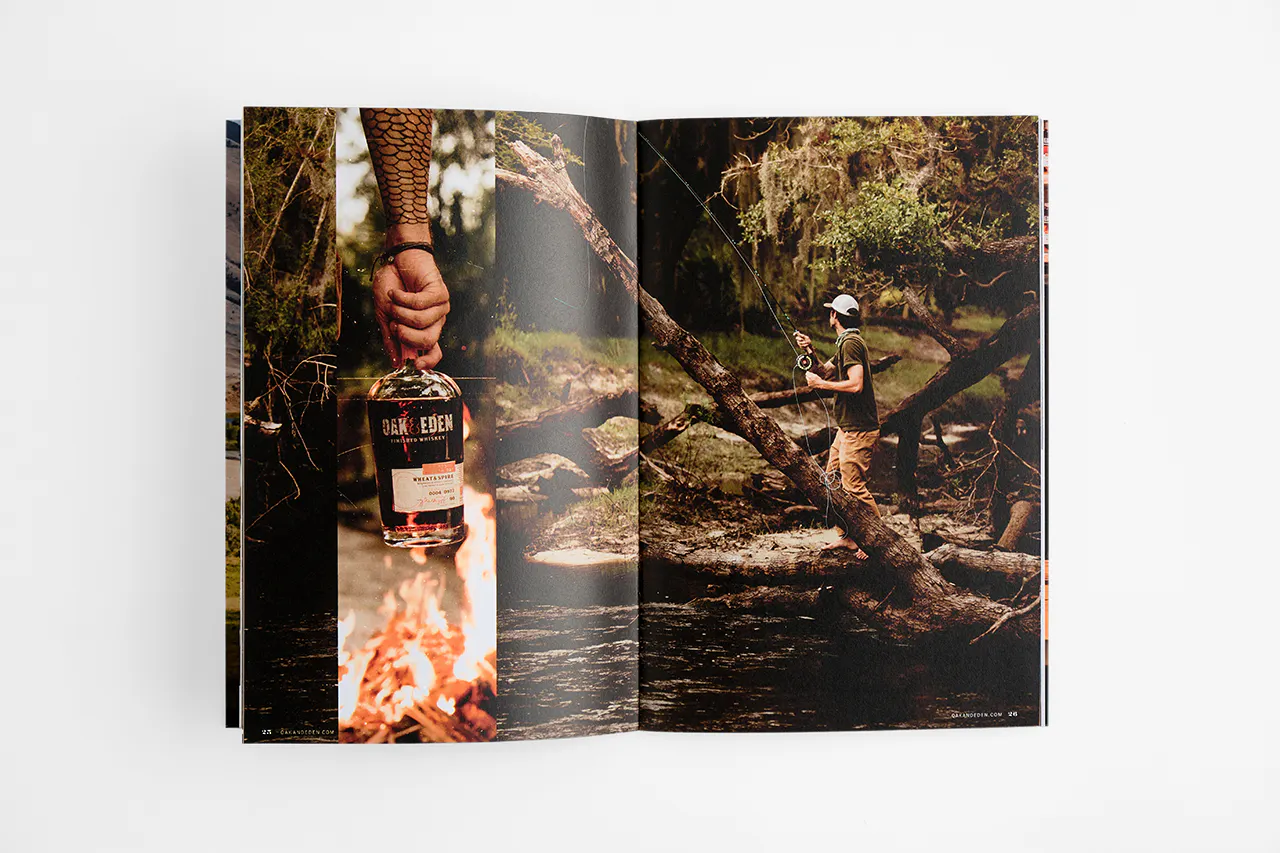 An Oak & Eden marketing booklet laying open to images of a man fishing and a hand holding a whiskey bottle.